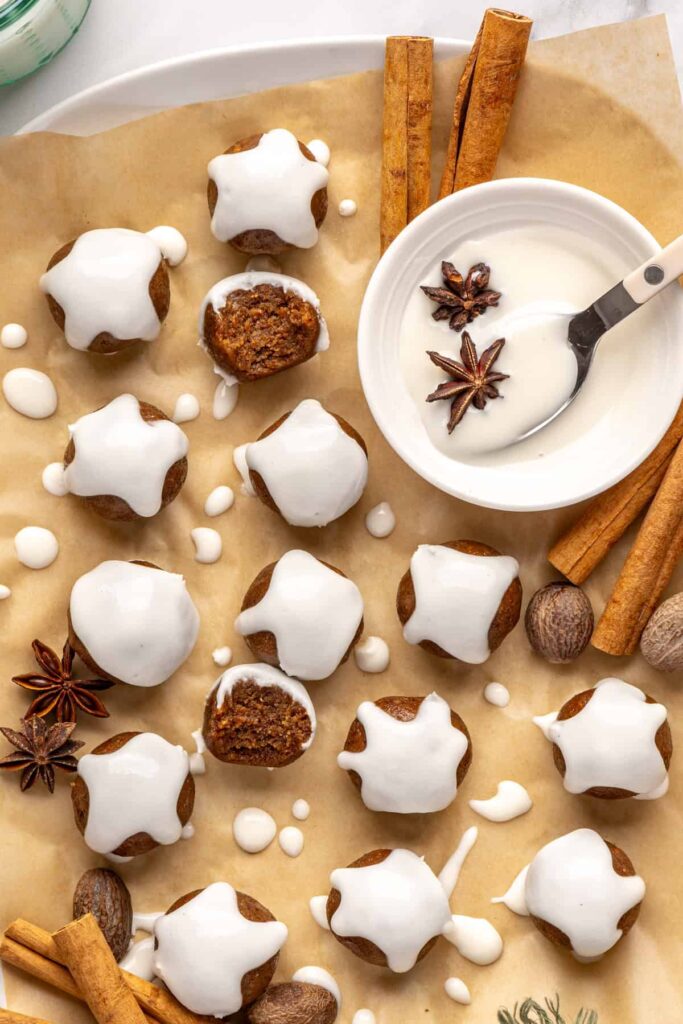 Chewy gingerbread protein balls with coconut butter drizzle and cinnamon, perfect for holiday snacks or meal prep