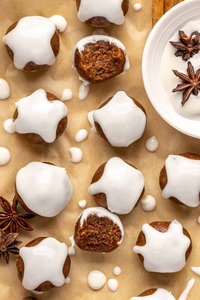 close up of chewy gingerbread protein balls with coconut butter drizzle, perfect for holiday snacks or meal prep
