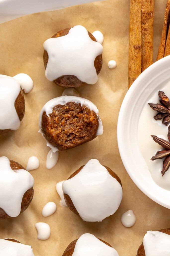 close up of chewy gingerbread protein balls with coconut butter drizzle, perfect for holiday snacks or meal prep