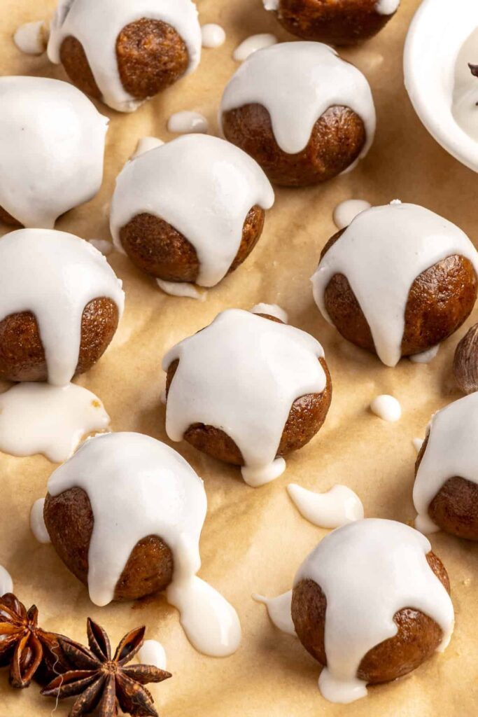 close up of chewy gingerbread protein balls with coconut butter drizzle, perfect for holiday snacks or meal prep