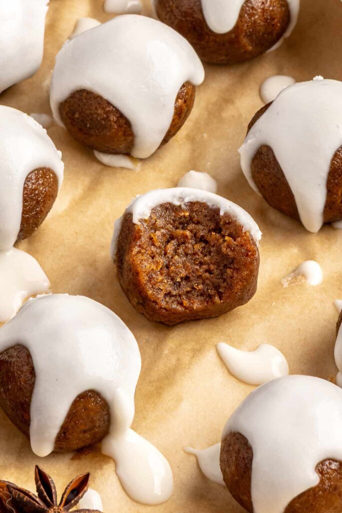 close up of chewy gingerbread protein balls with coconut butter drizzle, perfect for holiday snacks or meal prep