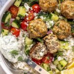Juicy Greek turkey meatballs served over rice with tzatziki and cucumber-tomato salad.
