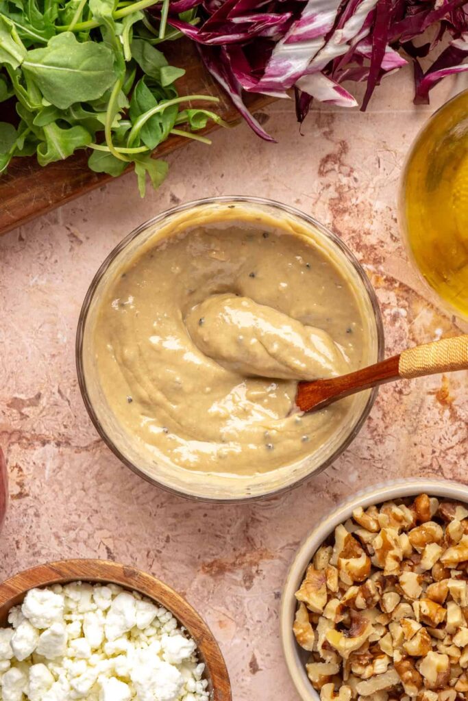Bowl of smooth tahini maple dressing used in harvest salad