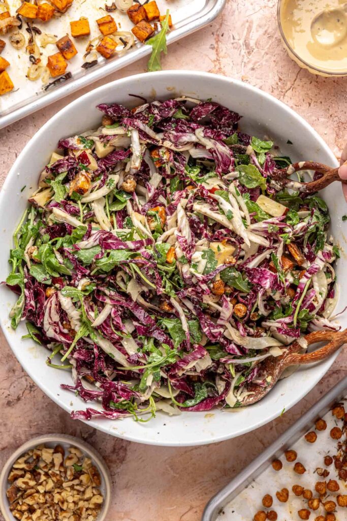 Tossing greens with roasted sweet potatoes and chickpeas for harvest salad
