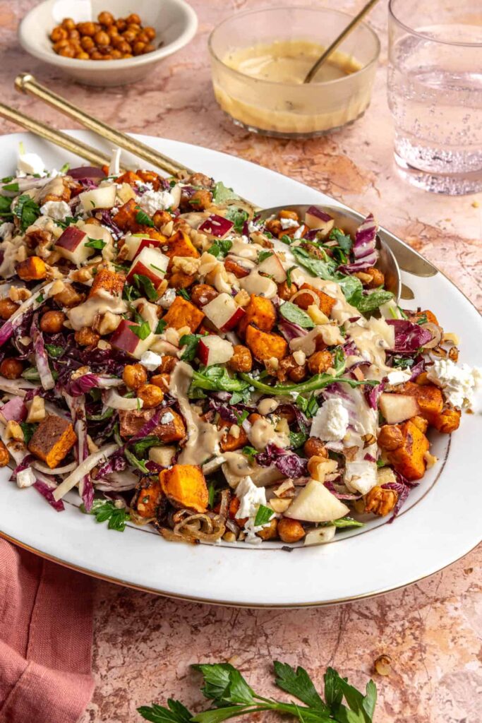 Colorful harvest salad with radicchio, frisée, fennel, apples, walnuts, and feta