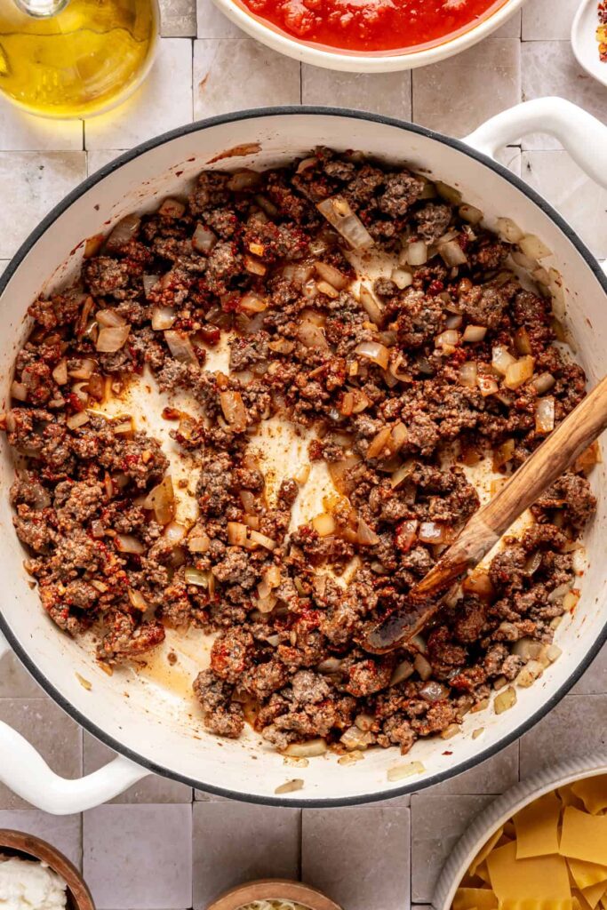 browning the ground beef with the sautéed aromatics for lasagna soup including onions and garlic