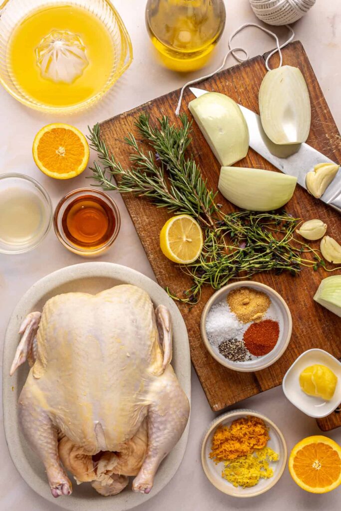 ingredients for Citrus Maple Chicken on a cutting board and on a table