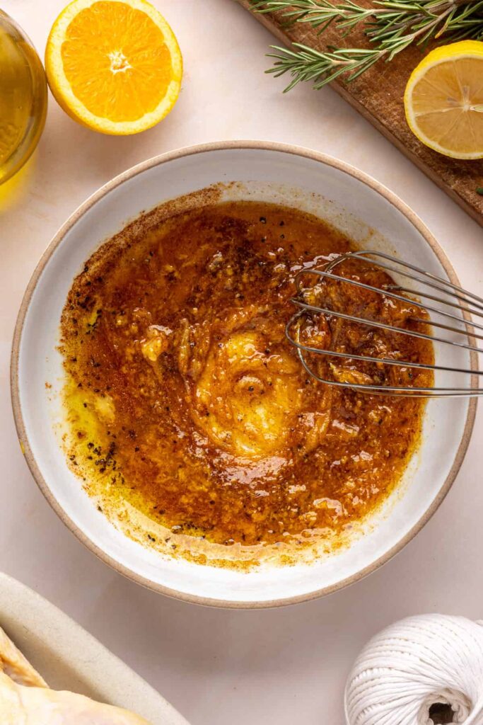 Making the maple-citrus glaze for Citrus Maple Chicken by whisking orange juice, lemon juice, zest, and maple syrup