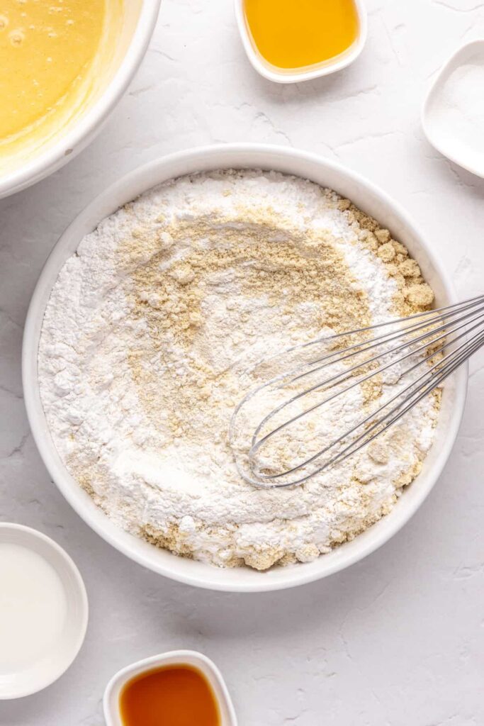 whisking dry ingredients in a bowl for healthy Christmas Sugar Cookies