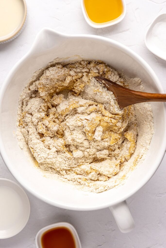 mixing together wet and dry ingredients in a bowl for gluten-free, refined-sugar free Christmas Sugar Cookies
