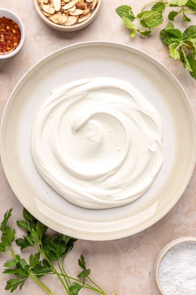 Blended whipped feta in a bowl for serving with roasted sweet potatoes