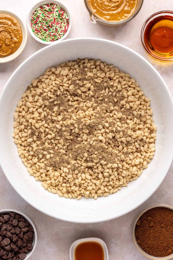 Brown rice cereal and ground flaxseed meal in a mixing bowl for salted peanut butter bars base