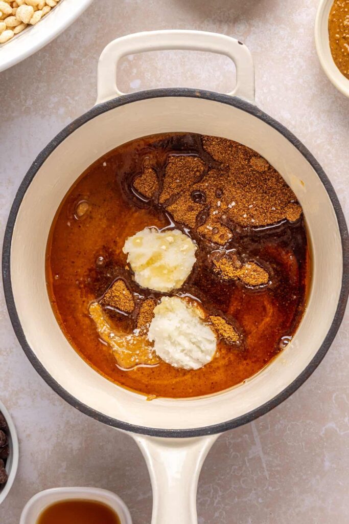 Ingredients for the peanut butter base layer of salted peanut butter bars in a pot, ready to be melted