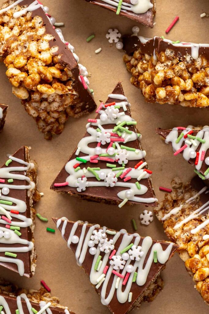 close-up of Christmas tree-shaped salted peanut butter bars with holiday sprinkles on top