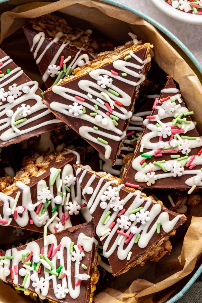 Close-up of salted peanut butter bars in a festive holiday tin, no-bake chocolate and peanut butter dessert