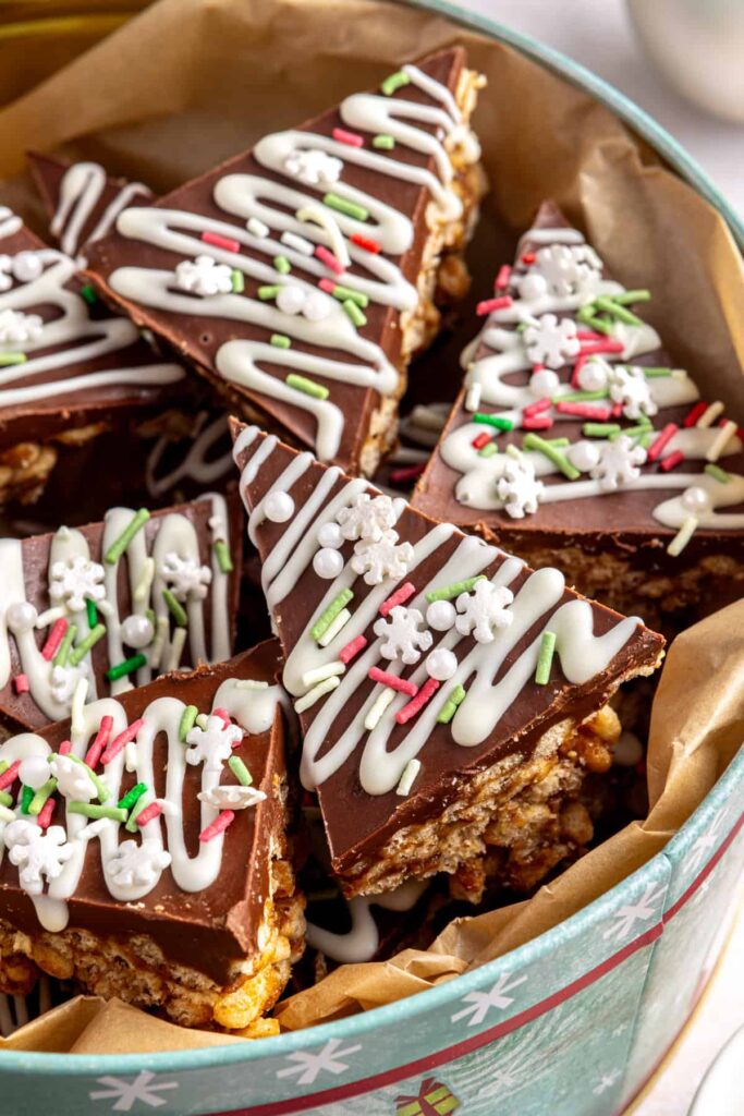 Close-up of salted peanut butter bars in a festive holiday tin, no-bake chocolate and peanut butter dessert