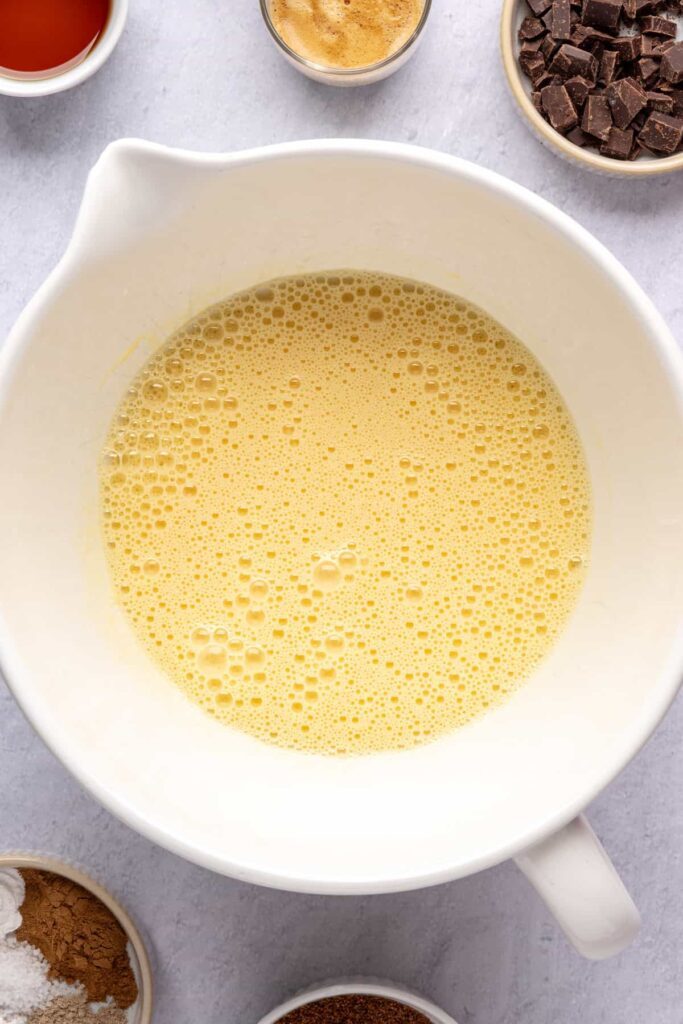 fully mixed and fluffy eggs and avocado oil for the pumpkin spice chocolate loaf batter.