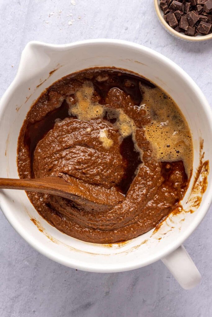 Combining dry and wet ingredients to form the pumpkin spice chocolate loaf batter.