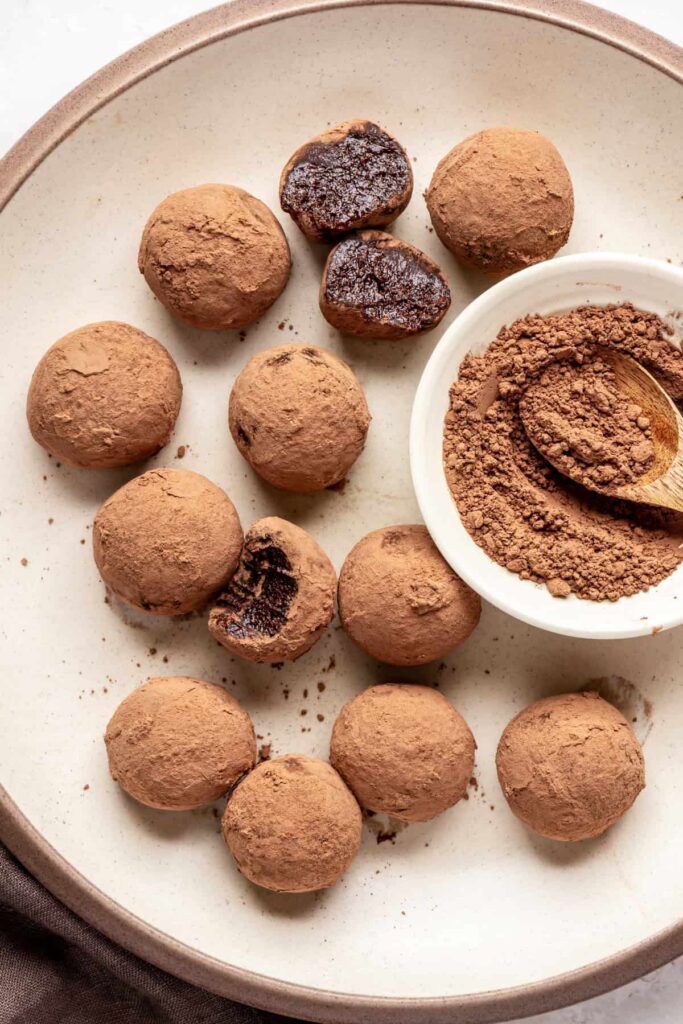 Finished protein brownie bites styled on a plate, rich and chocolatey no-bake snack