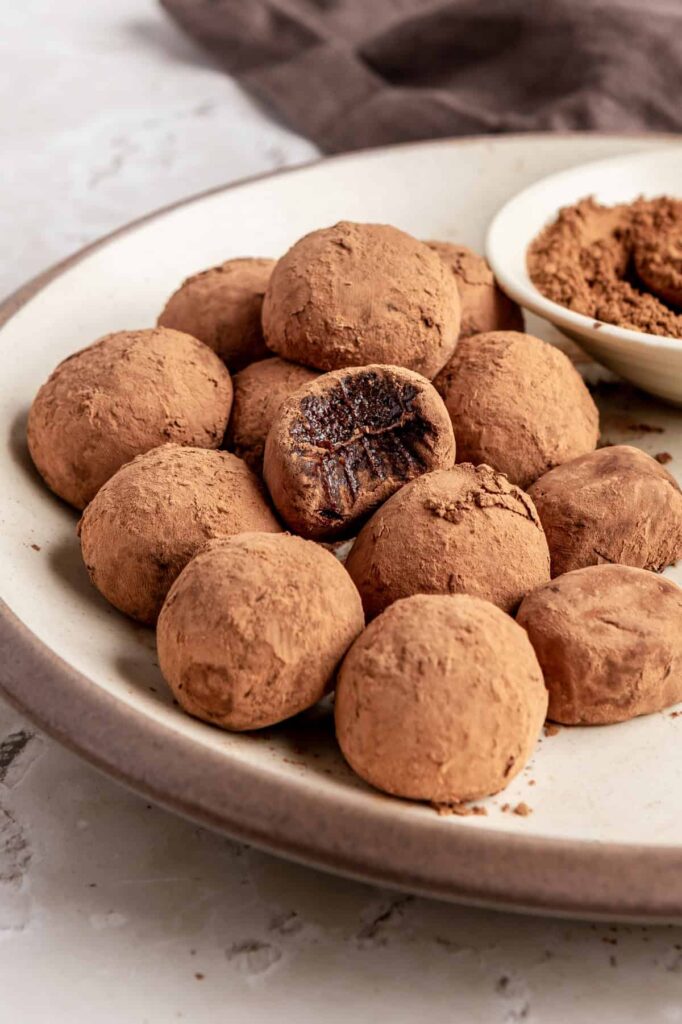 Finished protein brownie bites styled on a plate, rich and chocolatey no-bake snack