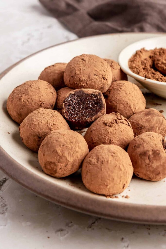 Finished protein brownie bites styled on a plate, rich and chocolatey no-bake snack