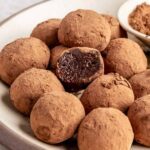 Finished protein brownie bites styled on a plate, rich and chocolatey no-bake snack