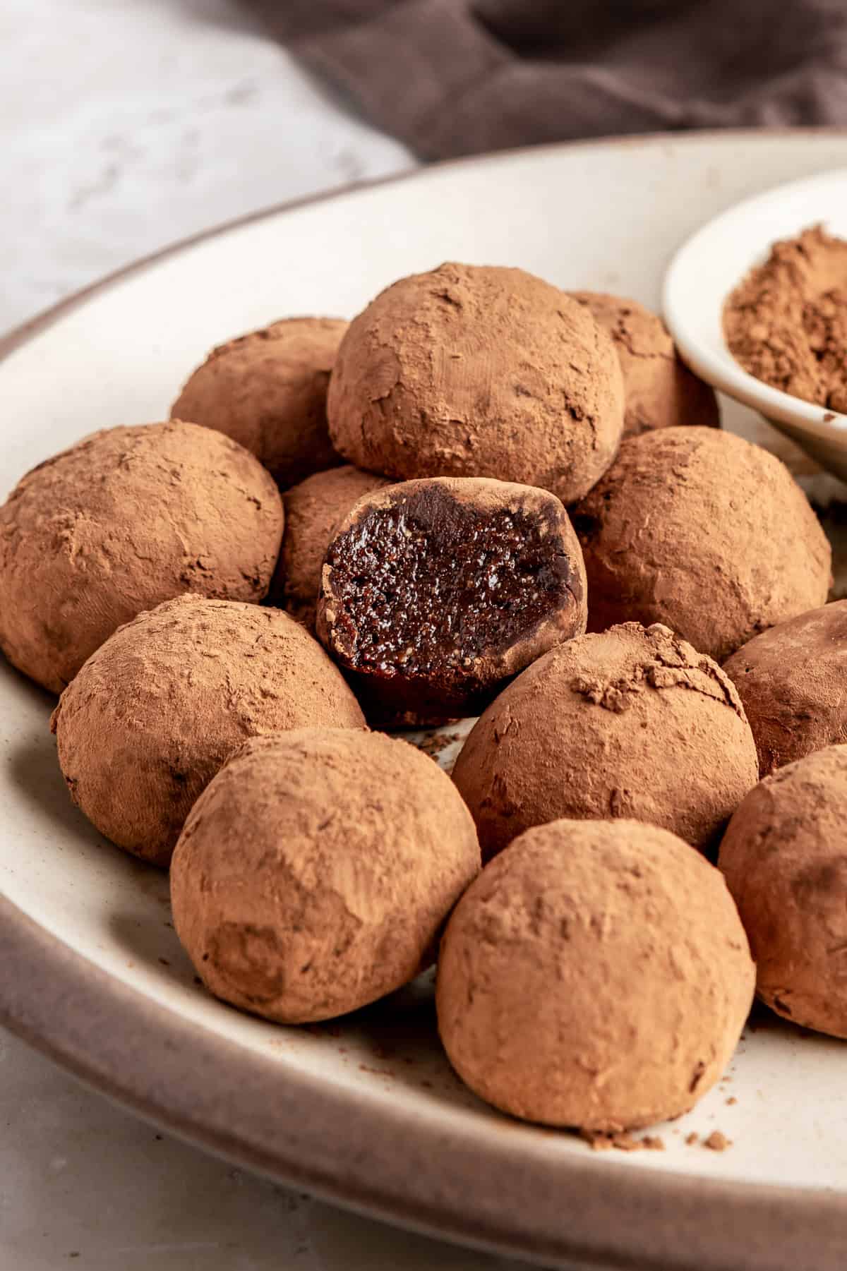 Finished protein brownie bites styled on a plate, rich and chocolatey no-bake snack