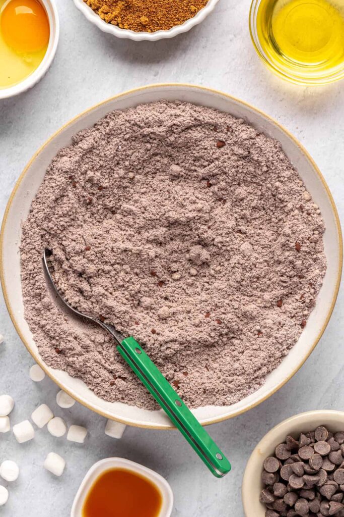 Whisking almond flour, arrowroot starch, cocoa powder, and espresso powder for hot cocoa cookie dough