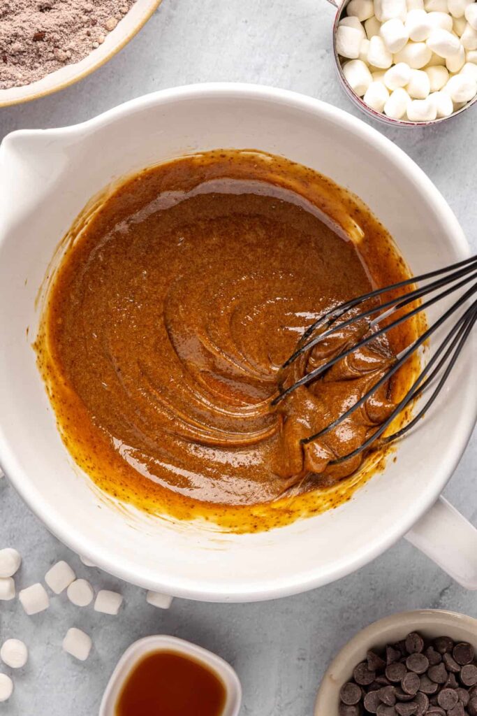 Whisking eggs, coconut sugar, and avocado oil for hot cocoa cookies