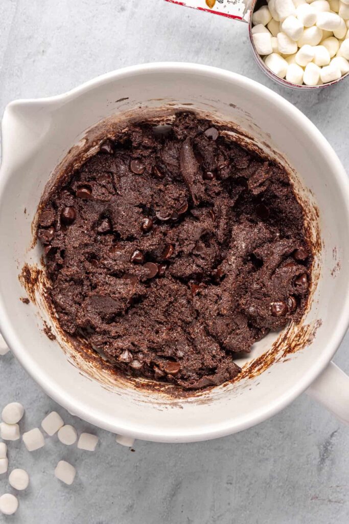 overhead shot of dough for hot cocoa cookies with chocolate chips folded in