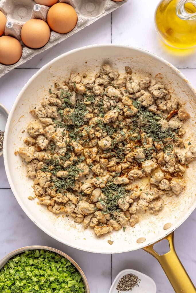 Golden, crispy maple sage chicken sausage in skillet for egg bake