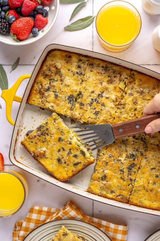 Slice of Chicken & Veggie Egg Bake being lifted from baking dish with a spatula