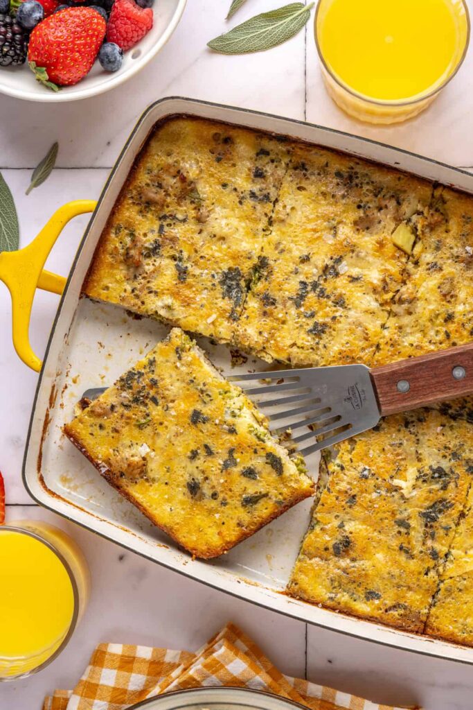 Slice of Chicken & Veggie Egg Bake being lifted from baking dish with a spatula