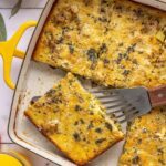Slice of Chicken & Veggie Egg Bake being lifted from baking dish with a spatula