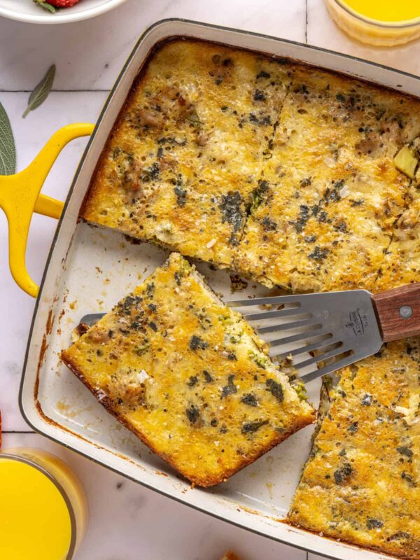 Slice of Chicken & Veggie Egg Bake being lifted from baking dish with a spatula