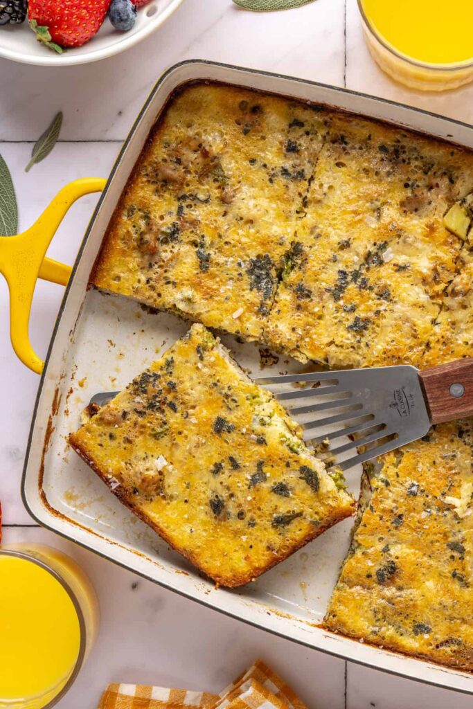 Slice of Chicken & Veggie Egg Bake being lifted from baking dish with a spatula