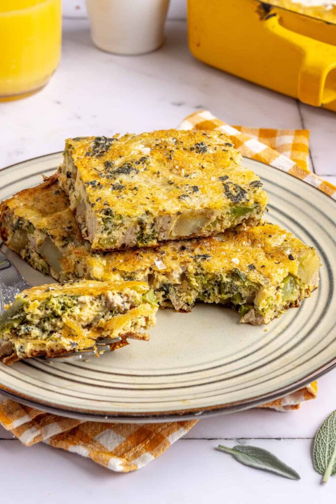 Side profile view of a slice of Chicken & Veggie Egg Bake showing layers of chicken, veggies, and eggs