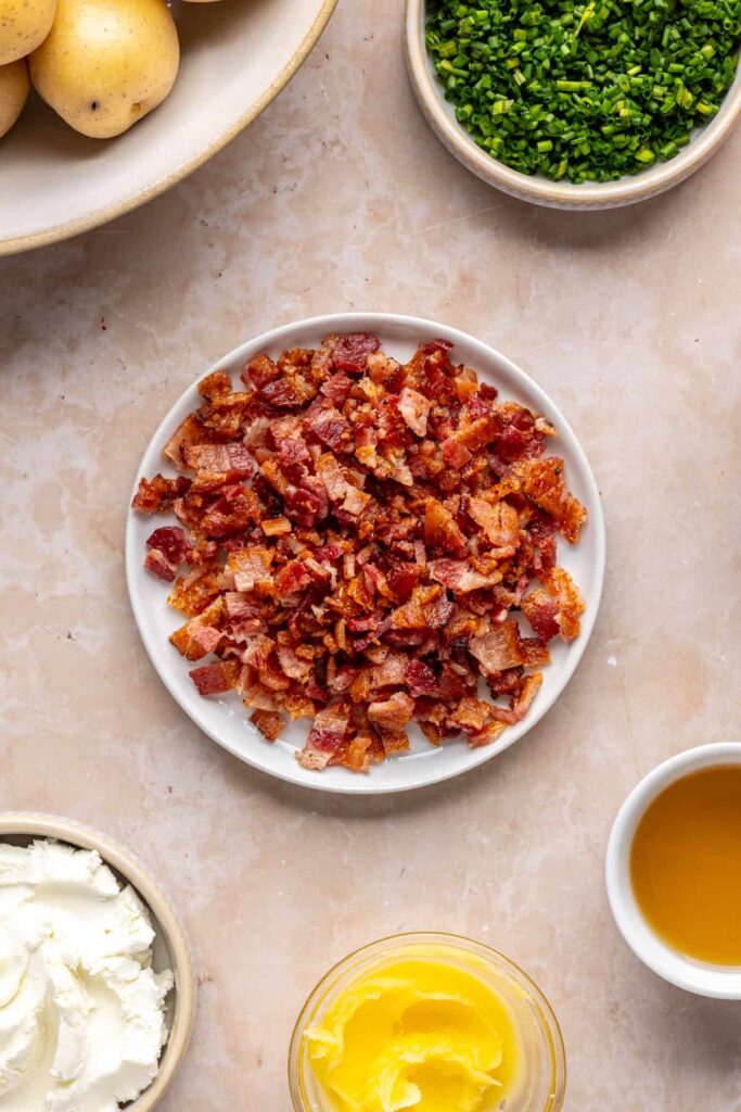 chopped crispy bacon bits set aside on a plate, ready to be added to the filling for twice baked potatoes