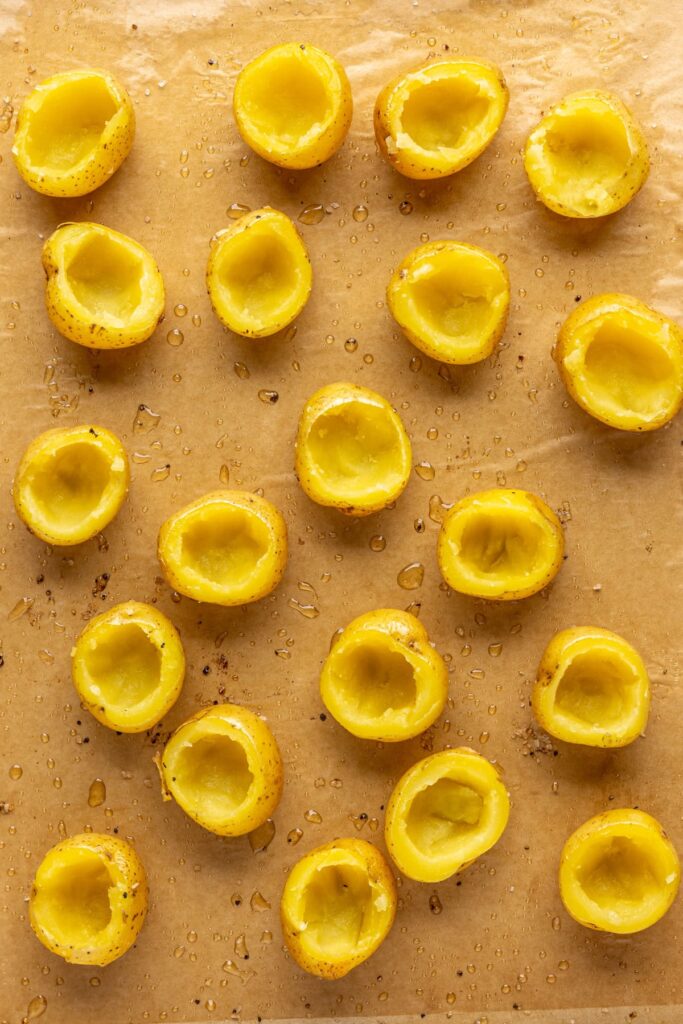 close up of centers removed from baked potatoes for twice baked filling