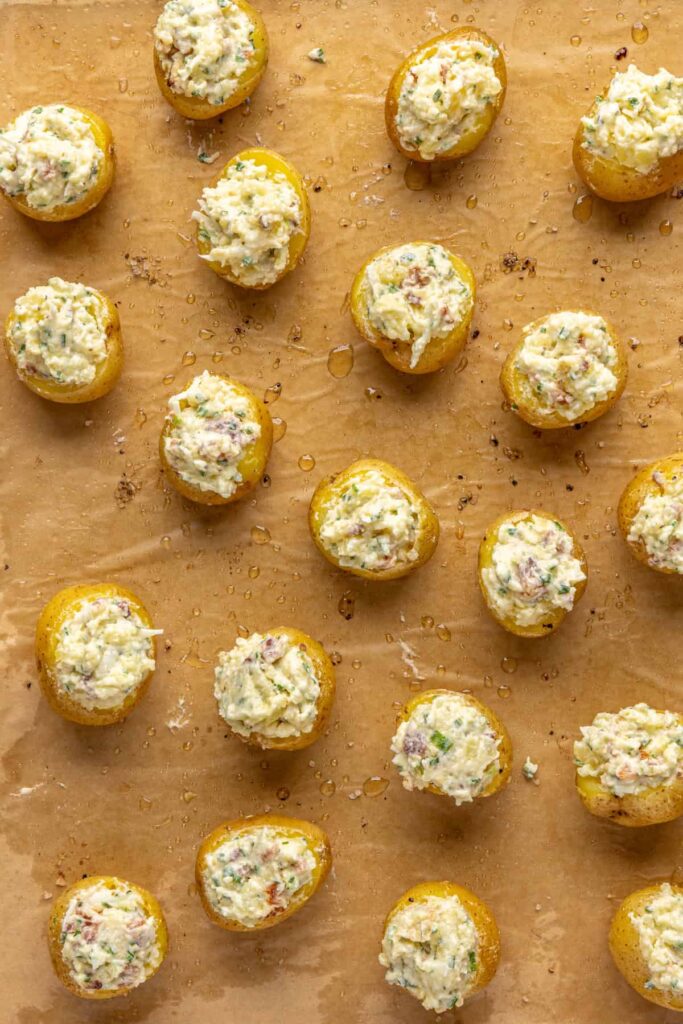 Filling being spooned into baked potato shells