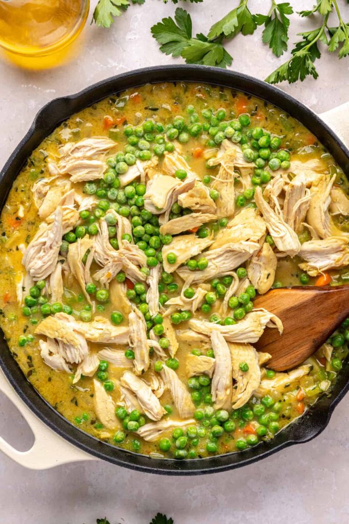 Shredded chicken and peas stirred back into skillet pot pie mixture.
