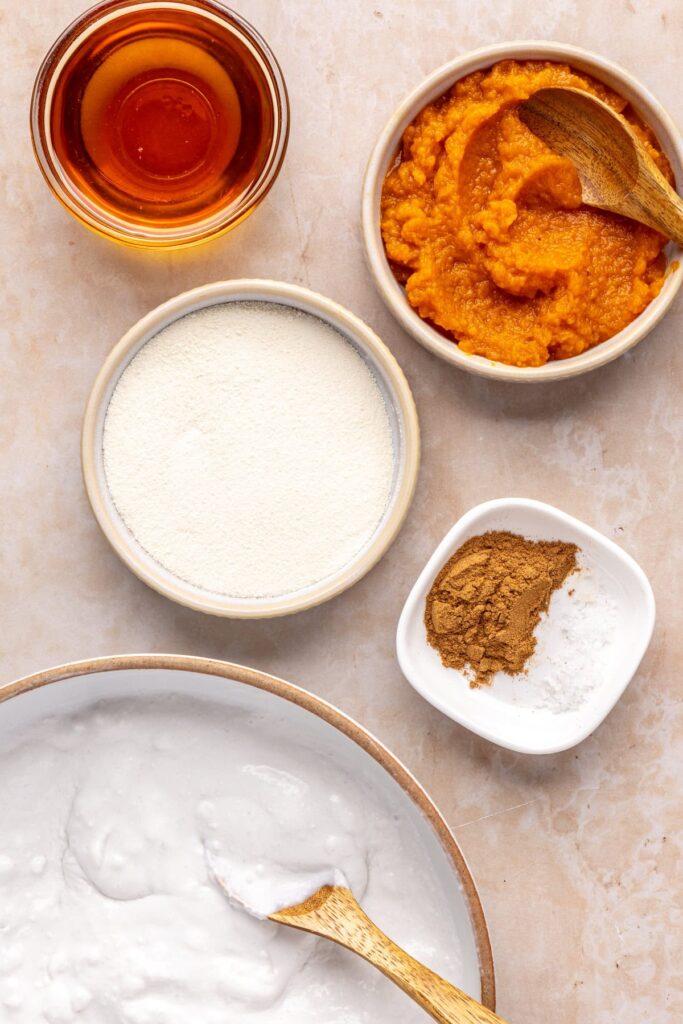 Overhead view of ingredients for pumpkin cold foam, including pumpkin, milk, and coffee