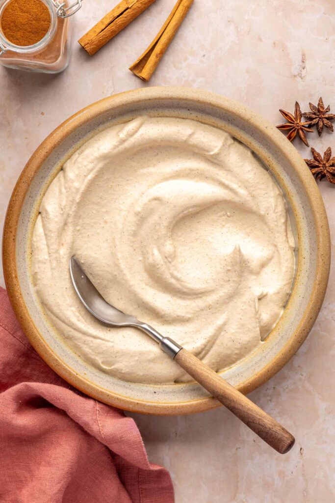 Fluffy pumpkin cold foam in a bowl with a spoon for serving