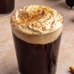 Pumpkin cold foam topped with pumpkin pie spice on iced coffee