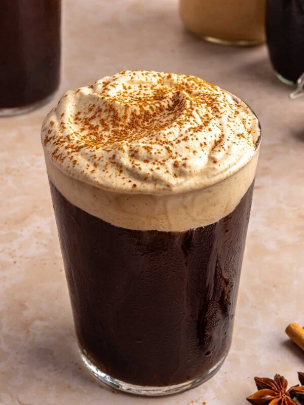 Pumpkin cold foam topped with pumpkin pie spice on iced coffee