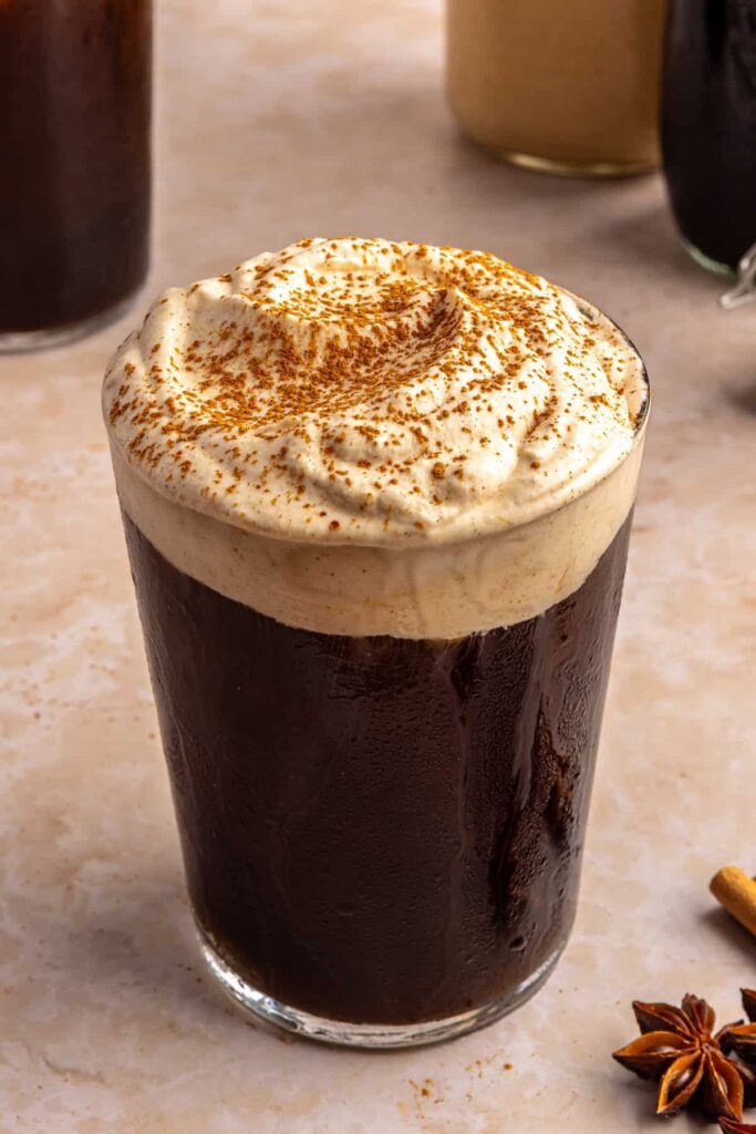 Pumpkin cold foam topped with pumpkin pie spice on iced coffee