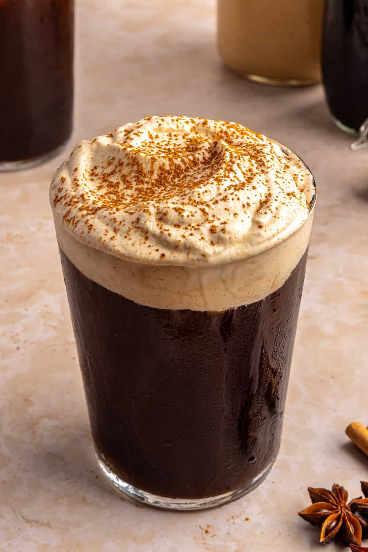 Pumpkin cold foam topped with pumpkin pie spice on iced coffee