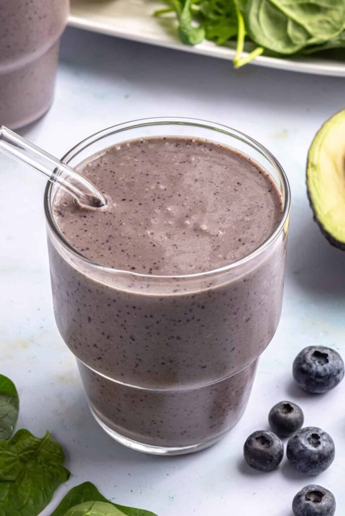 Toddler smoothie served in a glass with a reusable glass straw