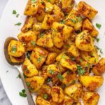 Herbed English roast potatoes served family-style on a platter