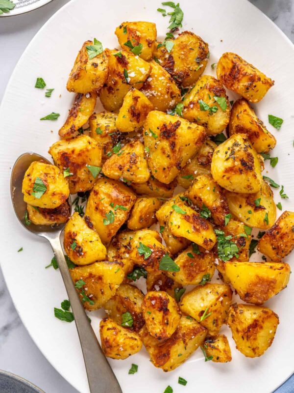 Herbed English roast potatoes served family-style on a platter